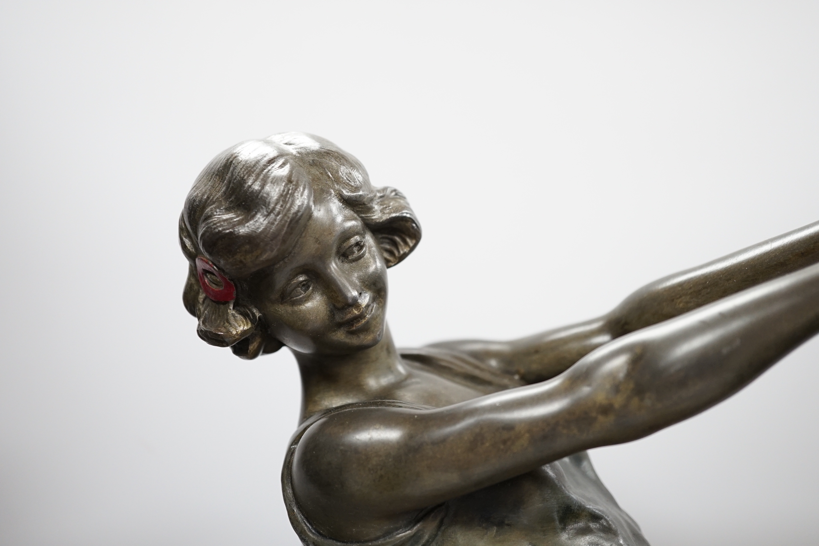 A spelter Art Deco figure of a woman, signed Carlier, on a stepped marble base, 52.5cm